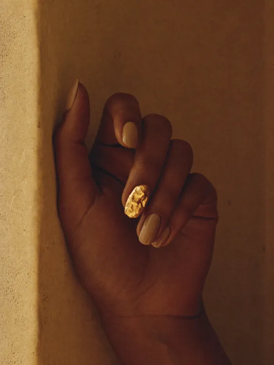 Soft taupe nails with a gold leaf fragment on one accent nail